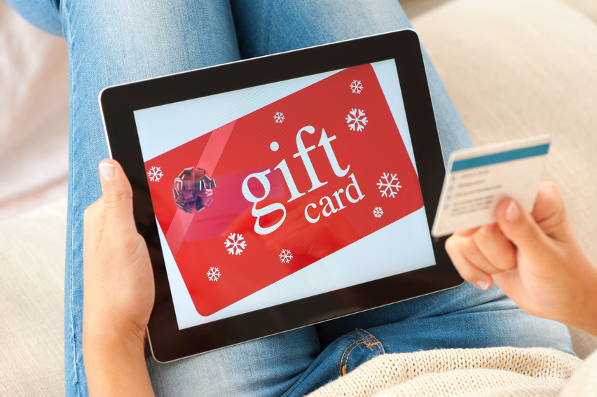 Woman buying gift card on a digital tablet